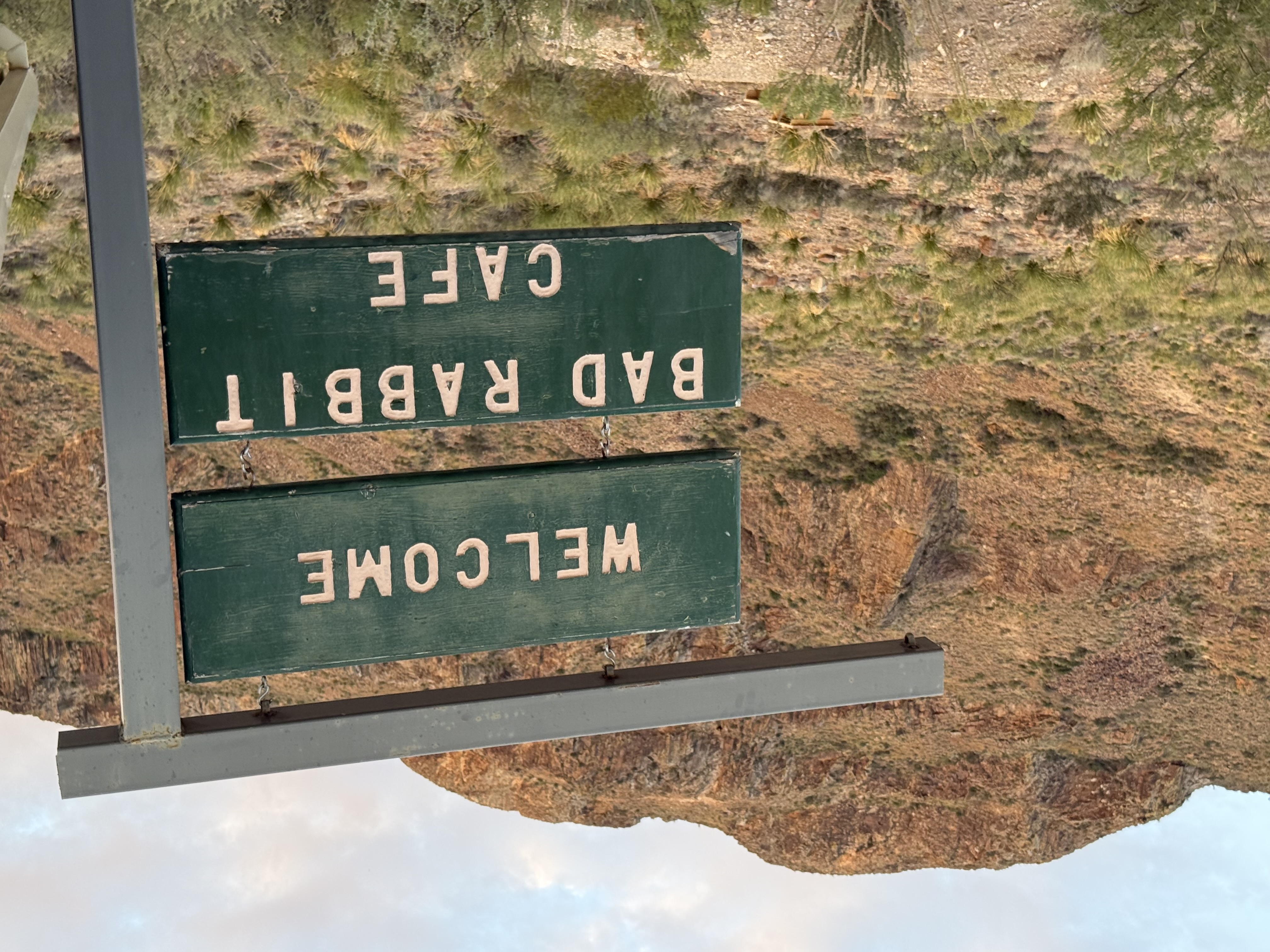 Bad Rabbit Cafe sign with mountain backdrop